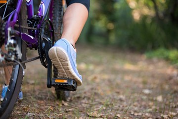 Female cyclist cycling in countryside