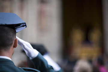 Obraz premium A Civil Guard saluting while a Holy Week procession, Seville, Spain