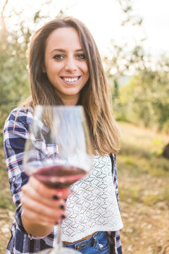 Woman holding glass with red wine