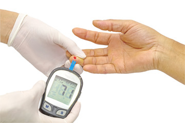 blood glucose meter, the blood sugar value is measured on a finger by female doctor in white...