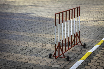 Outdoor parking barricades and yellow-white concrete sidewalk curb with traffic. yellow and white...