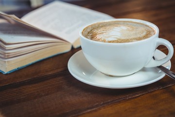 Cappuccino and book on table