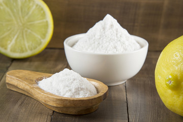 Baking soda and lemon on wooden table