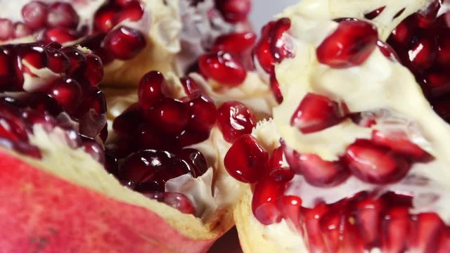 Opened pomegranate detail with beautiful red fleshy seeds