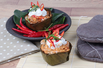 Streamed herb curry in banana leaf cup is spicy Thai organic food.