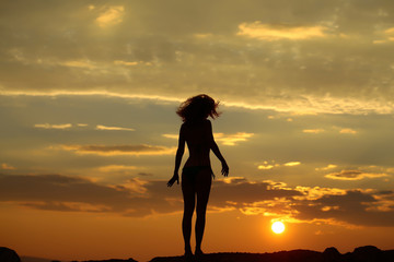woman silhouette in sunset beach