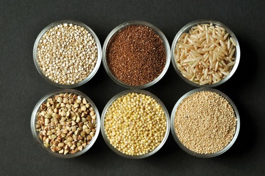 Selection of gluten-free grains in glass bowls top view close-up