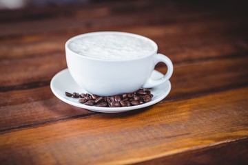 Coffee cup and beans on a table