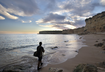 Man fishing on the beach, town of Porches, municipality of Lagoa, district of Faro, region of...