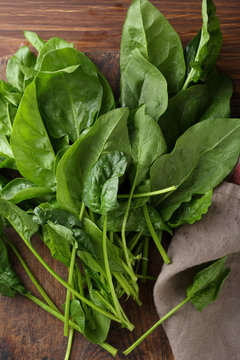 Fresh spinach leaves on old wood