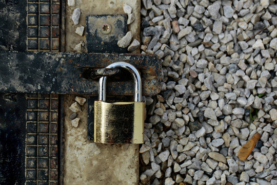 Padlock On Rusty Metal Gate