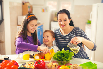 Mother making breakfast for her children in the morning