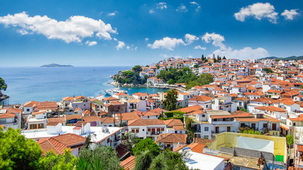 Naklejka na ściany i meble Skiathos town on Skiathos Island, Greece. Beautiful view of the old town with boats in the harbor.