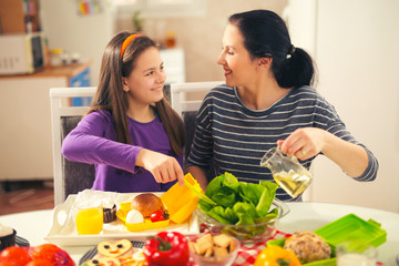 Mother making breakfast for her children in the morning and a snack for school at home