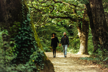 fashionable couple in green forest