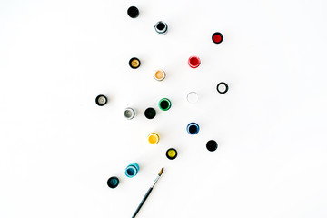 Watercolor and paintbrush on white background. Flat lay, top view