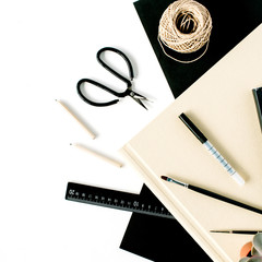 Flat lay, top view office table desk. Workspace with scissors, pencils, succulent and diary on white background.