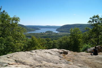 Overhead view from Bear Mountain Park, New York in the summer. Overlooking the Hudson River towards the big city. Visitors hike the mountain trails to the summit for fun and recreation. - obrazy, fototapety, plakaty