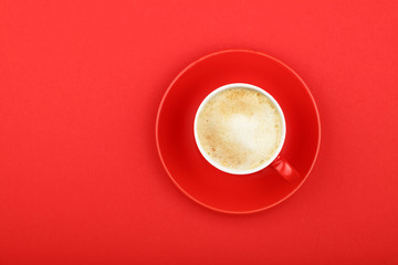 One latte cappuccino frothy coffee cup on red