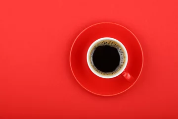 Rolgordijnen Americano coffee in full cup with saucer on red © breakingthewalls