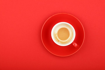 One empty latte cappuccino coffee cup on red