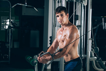 handsome bodybuilder works out pushing up excercise in gym