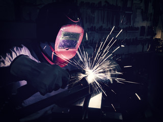Welder welding stainless steel.