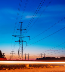 Electricity transmission power lines at sunset High voltage tower.