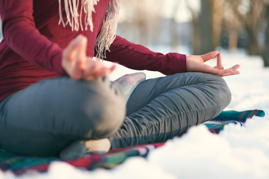 Attractive mixed race woman doing yoga in nature at winter time