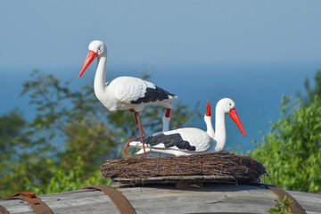 Toy nest of a stork with birds on it