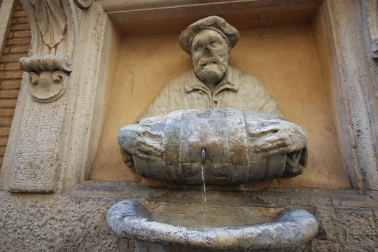 Historic drinking fountain in Rome, Italy named "Il Facchino" (The Porter) on the via Lata near Via del Corso