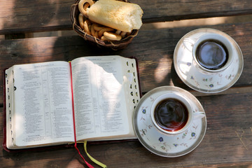On the table are filled with two cups of coffee scattered bones