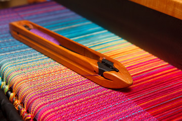 Weaving shuttle on the color warp