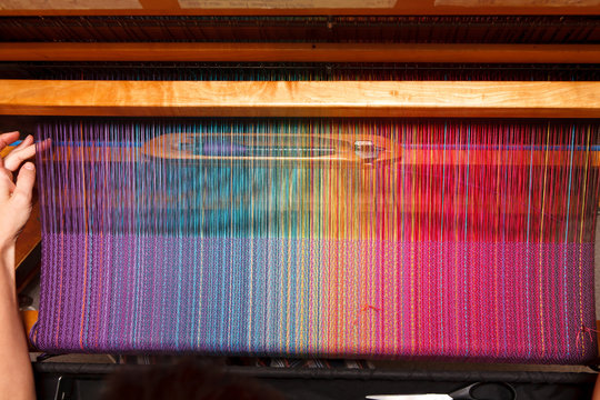 Woman's hands on the color warp