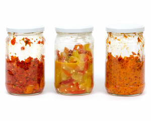 half a jar pickles or preserves on a white background