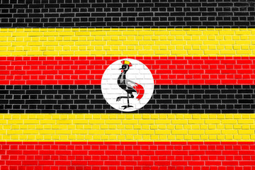 Flag of Uganda on brick wall texture background