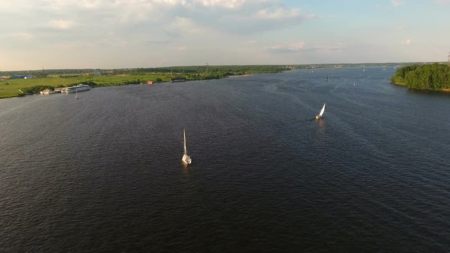 Sailing boat on the lake, the beautiful landscape, sky, clouds.Aerial view:Yacht on the surface of the lake on a sunny day.