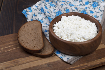 homemade cottage cheese in wooden bowl with eggs