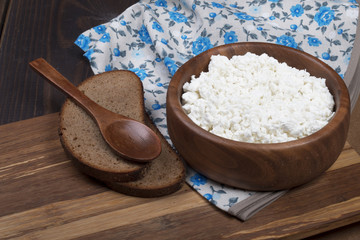 homemade cottage cheese in wooden bowl with eggs