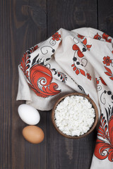 homemade fresh cottage cheese in wooden bowl with bread and towe