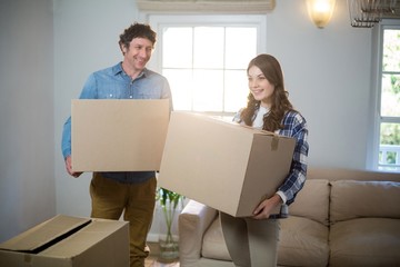 Couple holding cardboard boxes