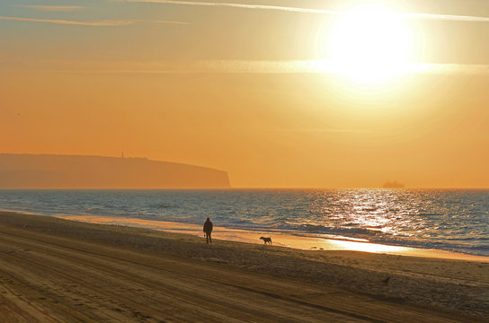Walking on the Beach at Sunrise