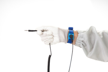 Bracelet on the hand of a man wearing ESD cloth and  glove stati
