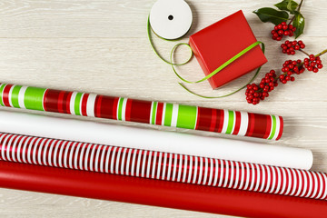 Red and green Christmas gift wrapping supplies. Christmas wrapping paper, gift box, present,...