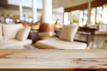 Empty wooden table on coffee shop background.