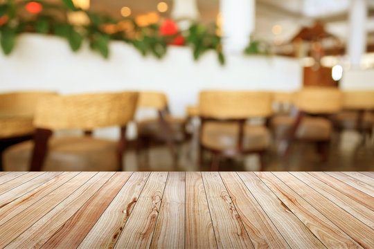 Empty wooden table on coffee shop background.