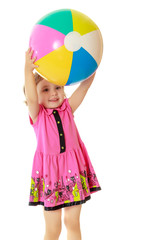 Girl holding ball over head
