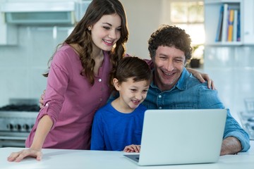 Happy family using laptop