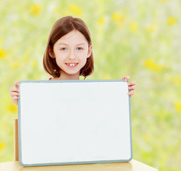Little girl holding white poster.