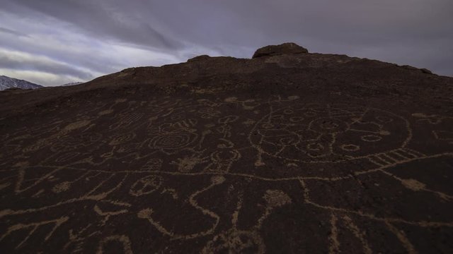 2 axis motion controlled time lapse with dolly pull & pan left motion of Native American Petroglyphs in the daytime in Eastern Sierra, California